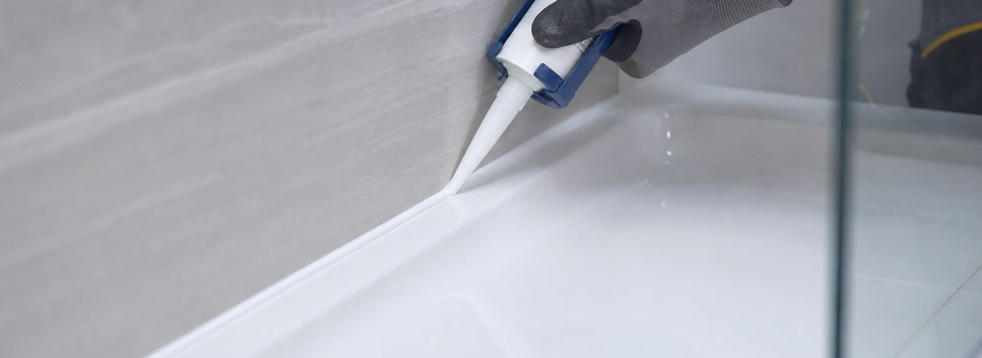 Internal sanitary sealant replacement on a bath in a Yorkshire bathroom - old, mouldy silicone removed and replaced with mould-resistant sealant.
