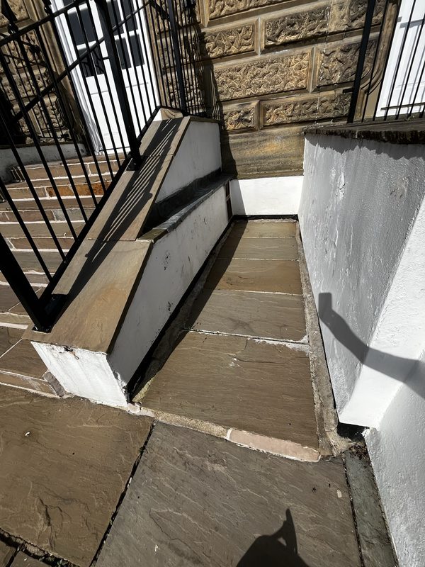 Failing paved path joints and unsealed lead flashing at Wells House, Ilkley - before repointing and reseal works.