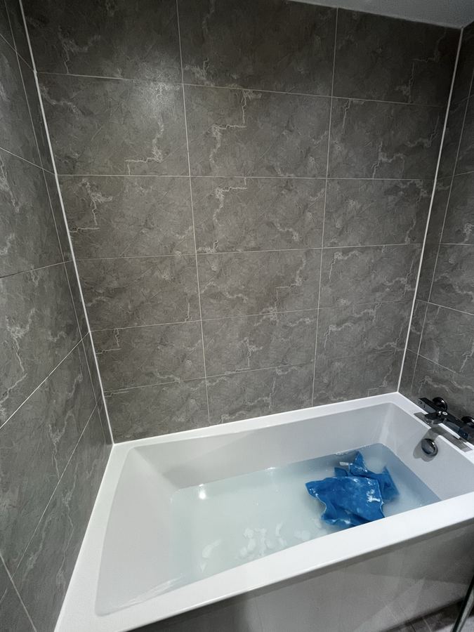 Replacement sanitary sealant in a Baildon bathroom - neat new bead after full removal of failed, mouldy silicone.