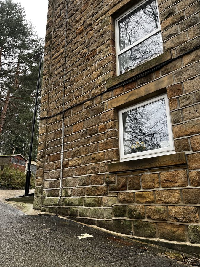 Weatherstruck repointing close-up on a converted tannery in Otley - uniform joints across original Yorkshire stone.