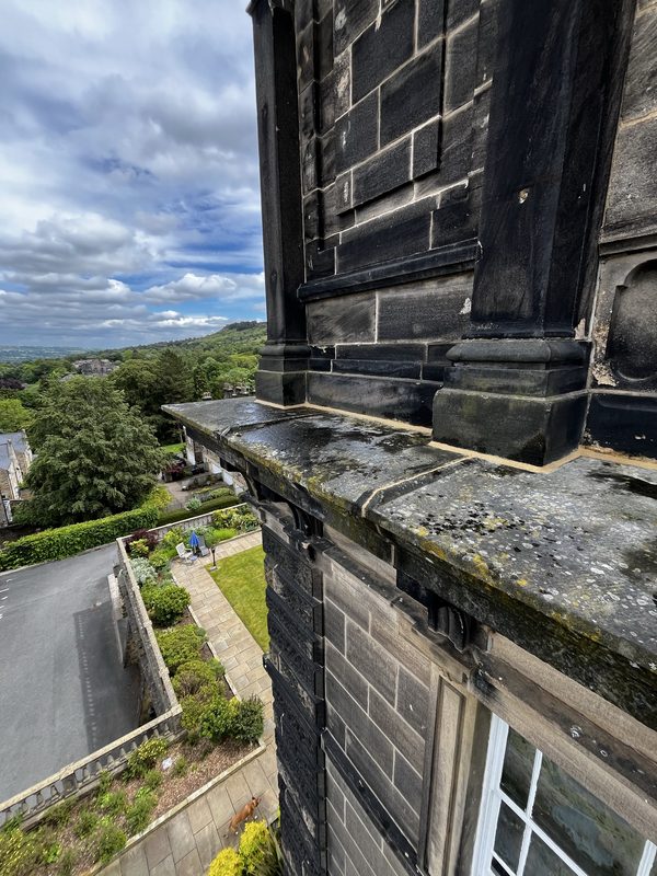 High-level cornice repointing detail at Wells House, Ilkley - heritage lime mortar specified for the Victorian stone substrate.