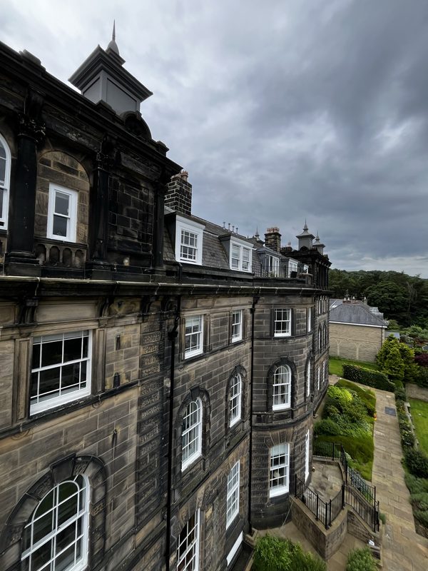 Wells House, Ilkley - full facade view showing completed heritage lime mortar repointing across the ornate Victorian cornice and stonework.
